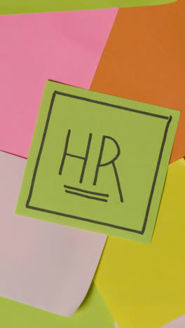 Vertical-Video-Business-Concept-Of-Revolving-Sticky-Notes-With-HR-Written-On-Top-Note-1